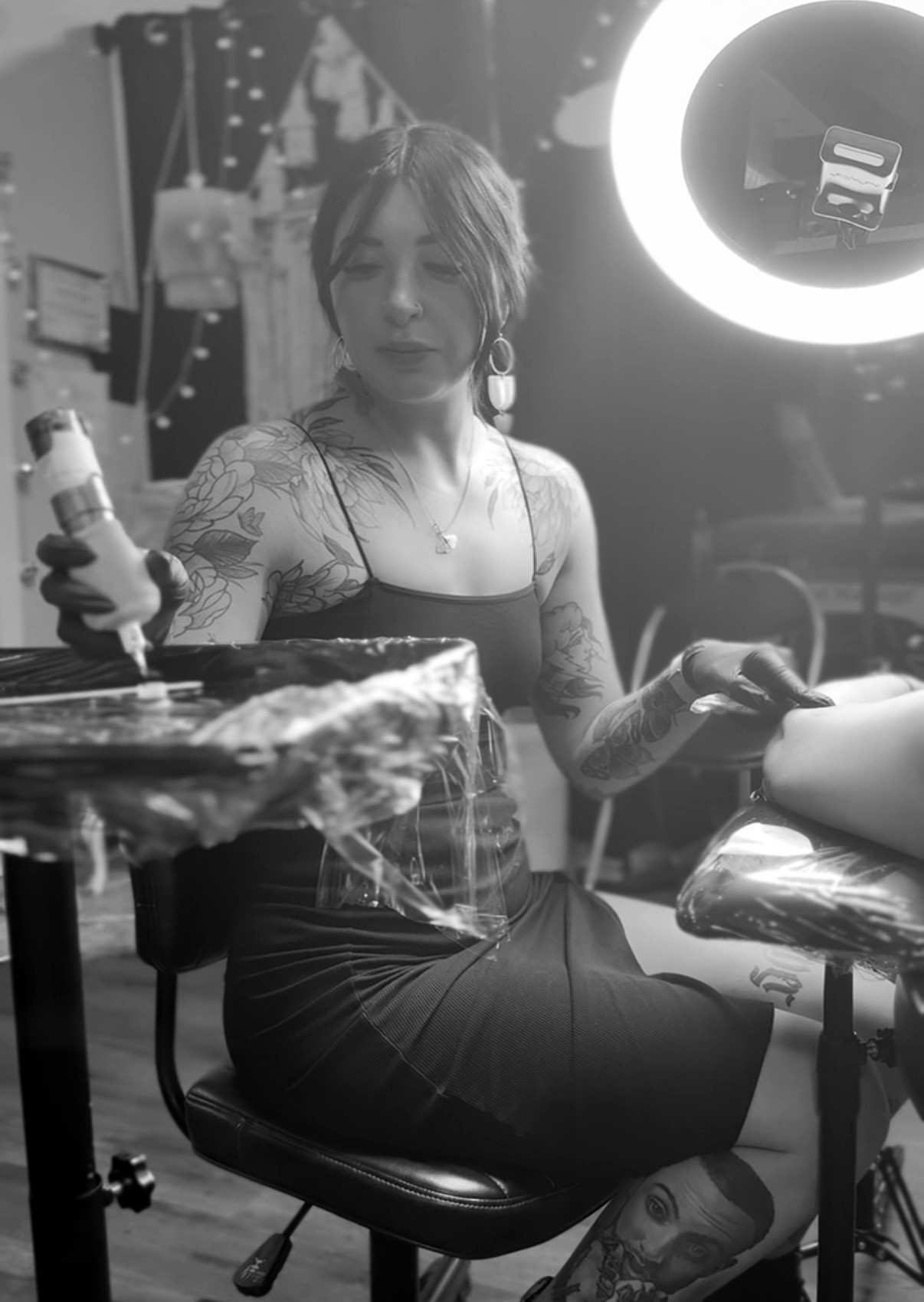 Maddy tattooing a client in the studio