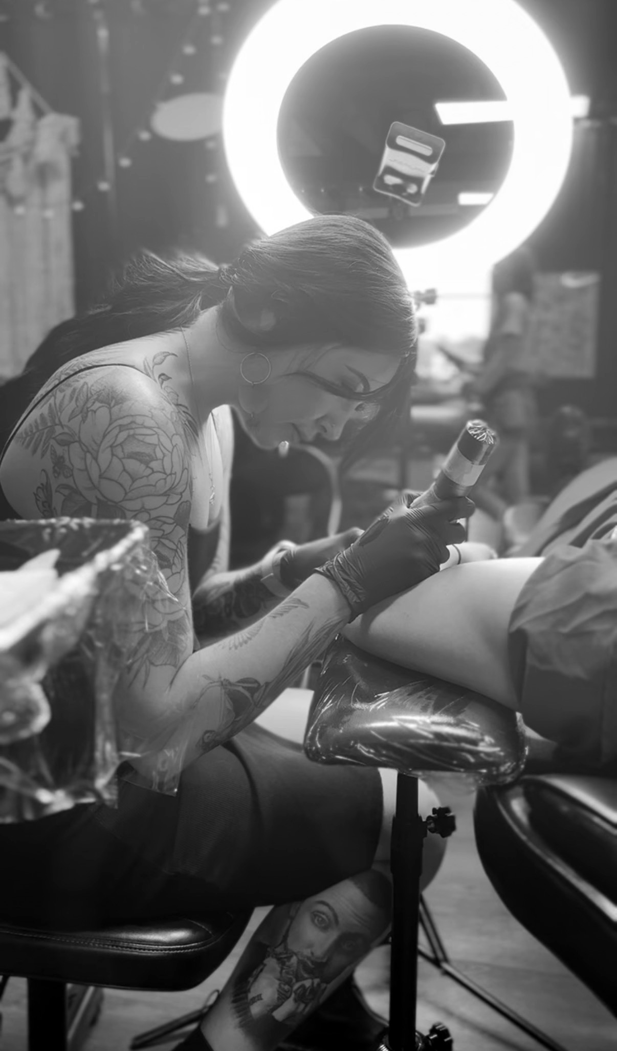 Maddy tattooing a client in the studio